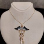 Gold Angel Wing Necklace with Shiny Stone Key Symbol 14K